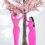 A long dress with an open waist and cowl neck adorned with a dahabi necklace